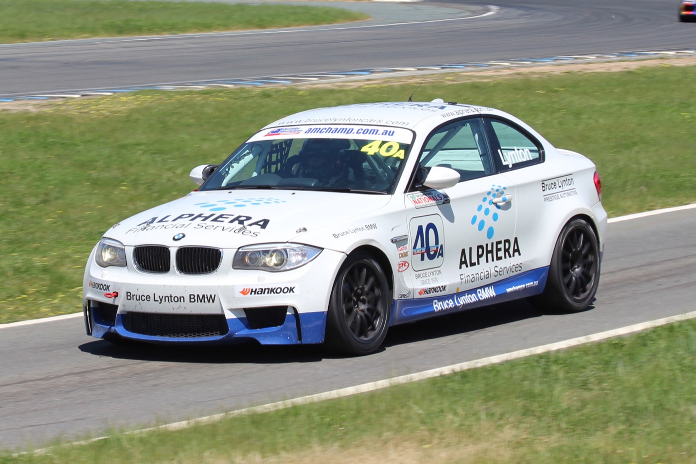 White and blue BMW 1M race car number 40 cornering at Wakefield Park